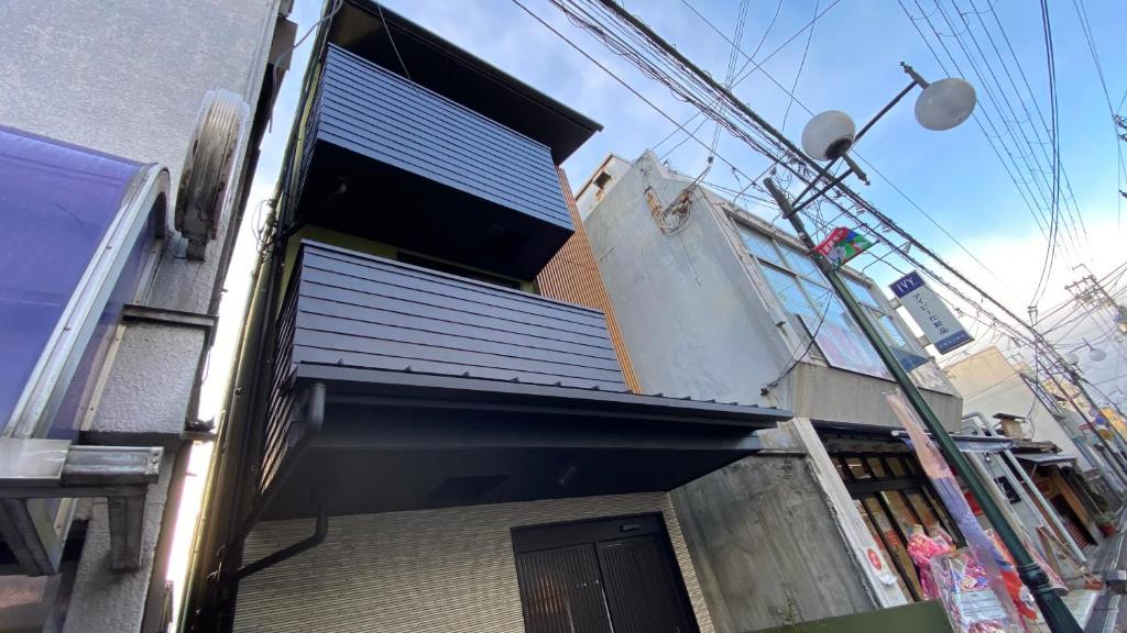 a building with a door on the side of it at One More Heart Fushimi Inari in Momoyama-chō