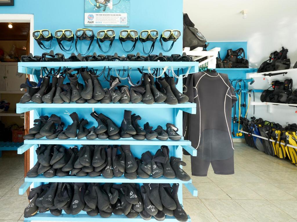 a bunch of shoes on shelves in a store at Anda Amed Villas & Spa in Amed