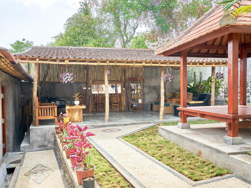 a wooden pavilion with a picnic table in a yard at Anda Amed Villas & Spa in Amed