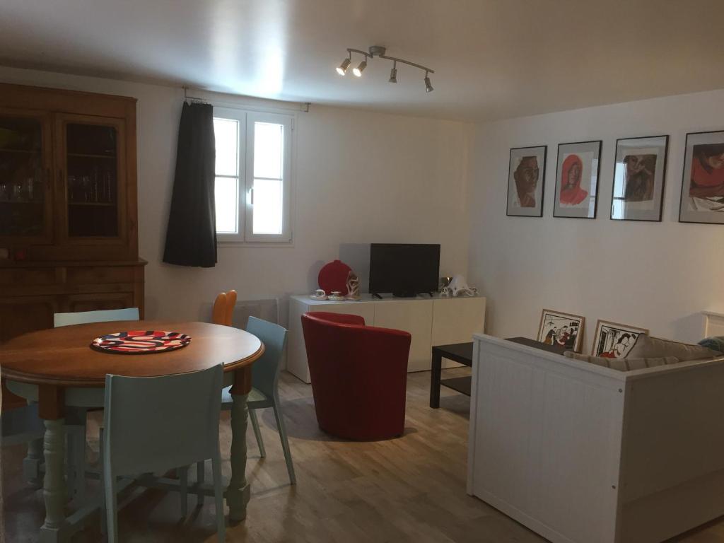 a living room with a table and chairs and a kitchen at Appartement Le Palais, 2 pièces, 4 personnes - FR-1-418-219 in Le Palais