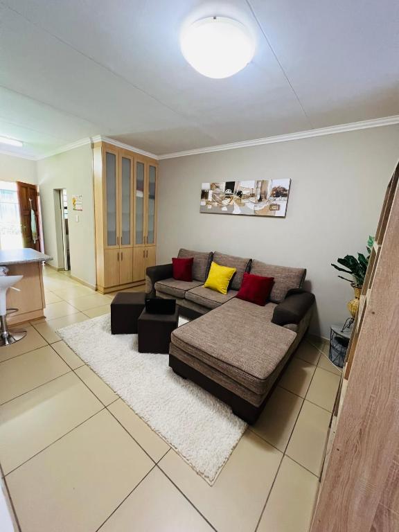 a living room with a couch and a table at Lighthouse Inn in Bloemfontein