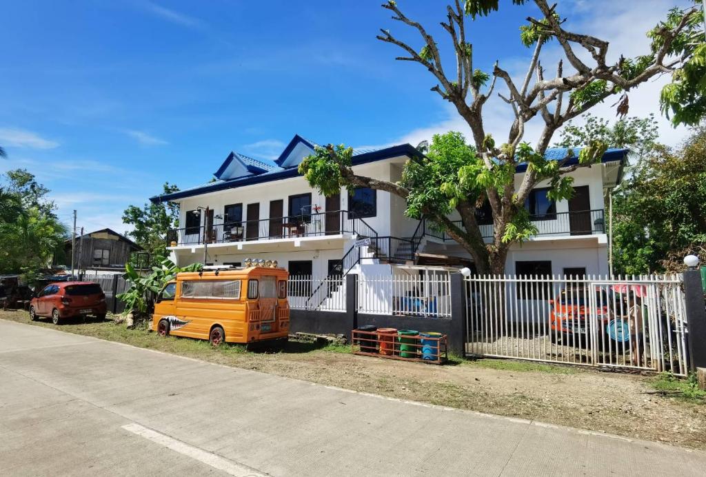 an orange van parked in front of a house at MoonViews Apartment in Panglao