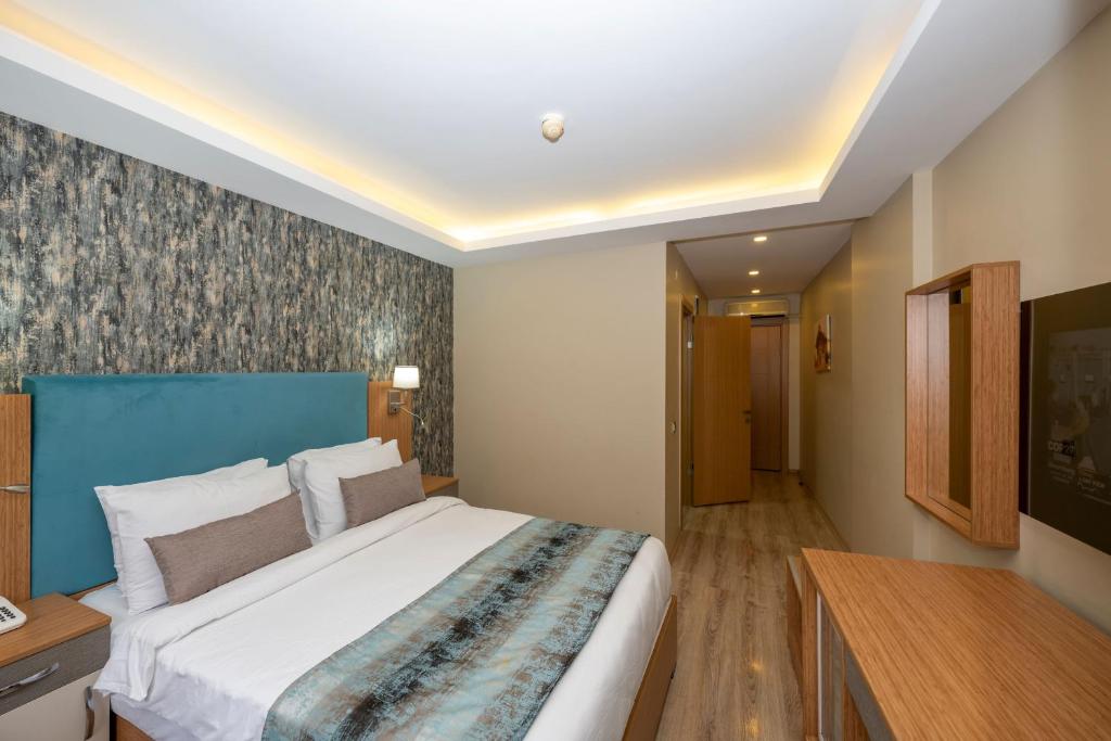 A bed or beds in a room at Hotel Devman