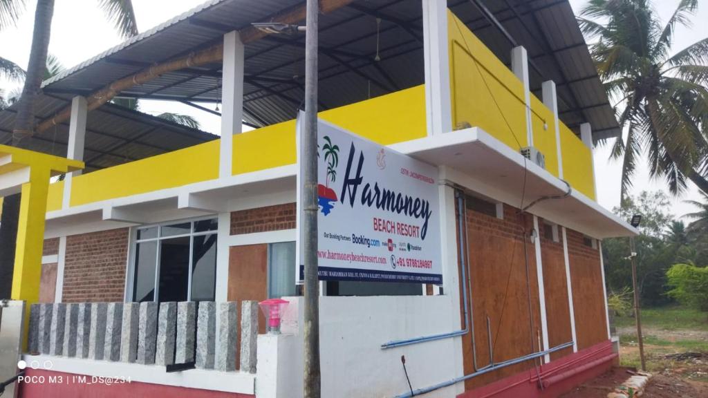 a building with a sign in front of it at Paradise Harmony Beach Resort in Singānallūr
