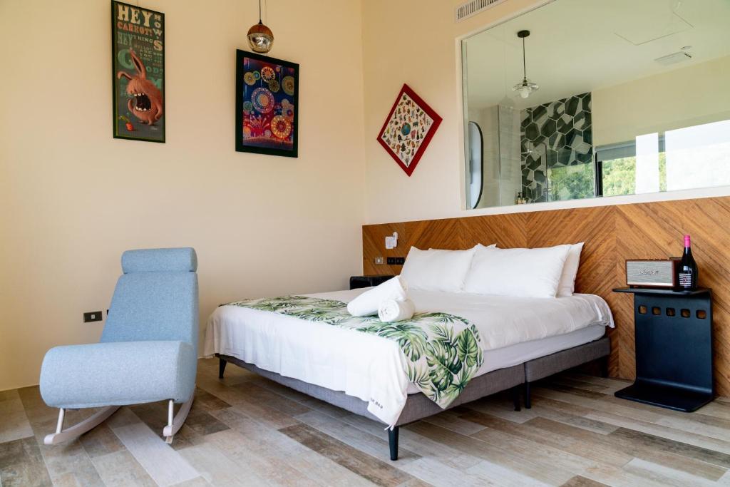 a bedroom with a bed and a blue chair at Shark B&B in Hengchun