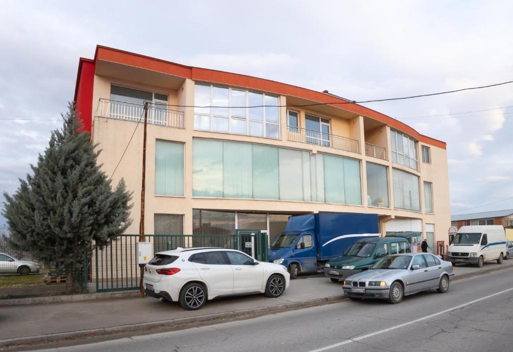 two cars parked in front of a building at Студио за четирима в село Ягодово, на 5 км от Пловдив и летище Крумово in Yagodovo