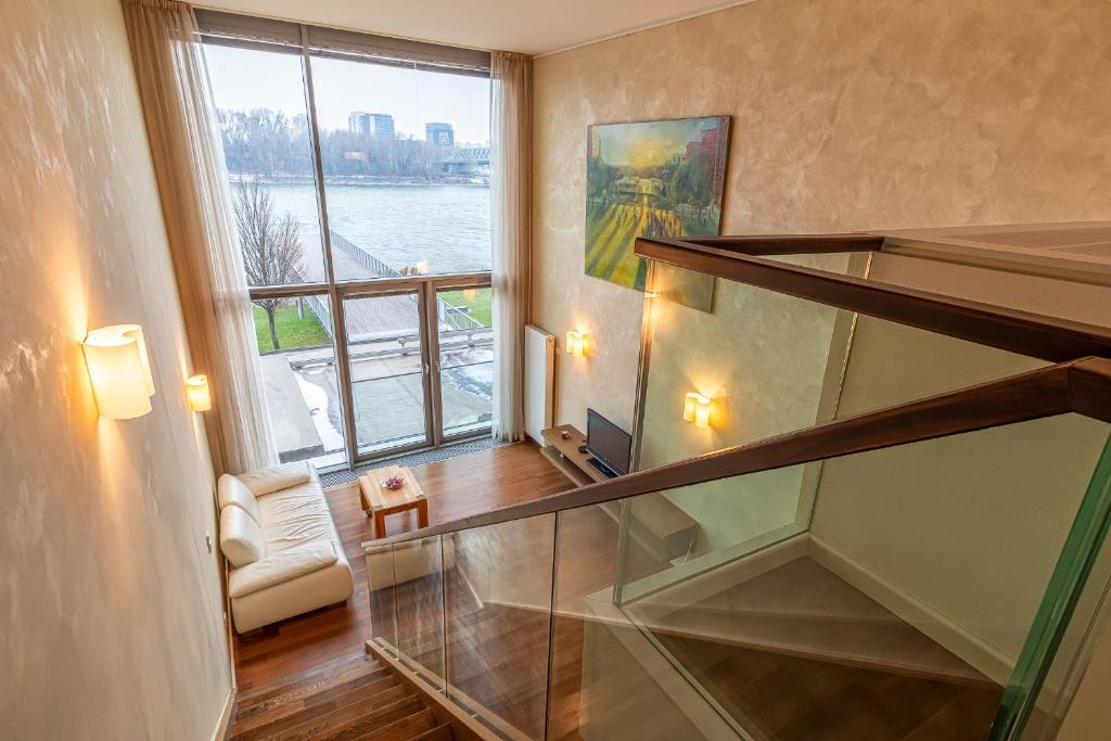 a glass staircase in a room with a window at Luxury with Danube river view in Petržalka