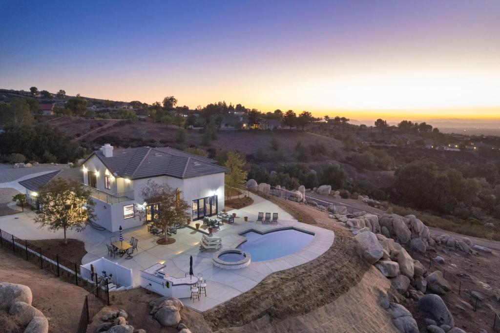 an aerial view of a house with a swimming pool at Chateau Evie James -High End Luxury Home withPool,Hot Tub,Gameroom home in Temecula