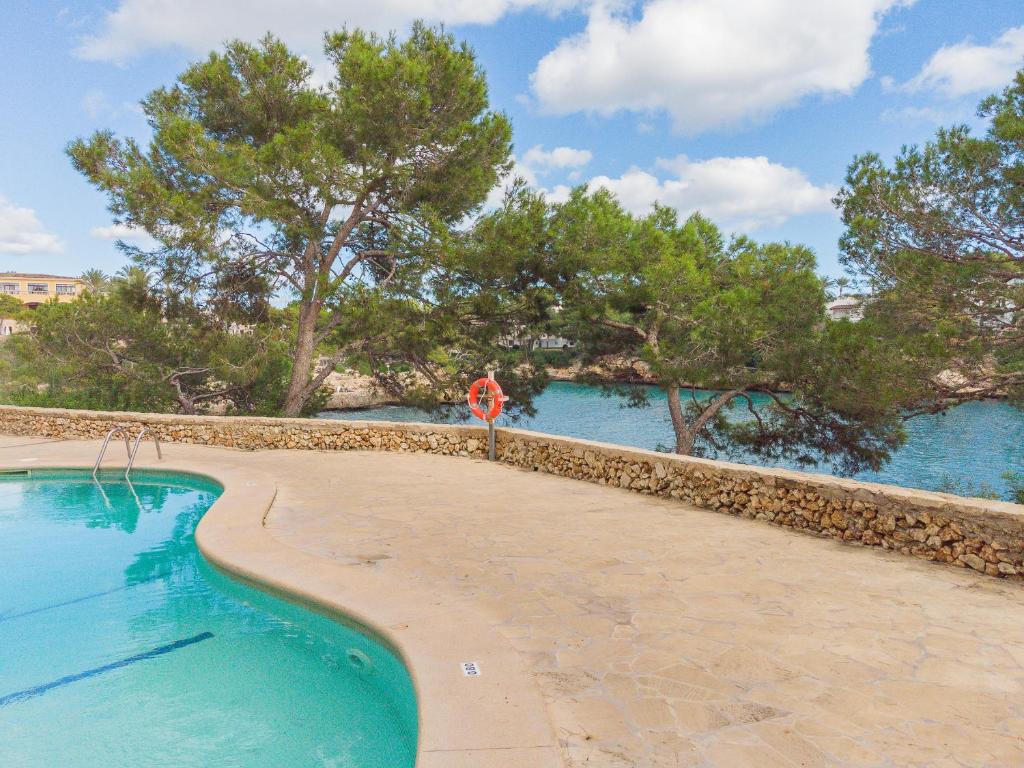 a swimming pool with a stop sign next to the water at Apartamento Ferrera Park 607 in Cala Ferrera