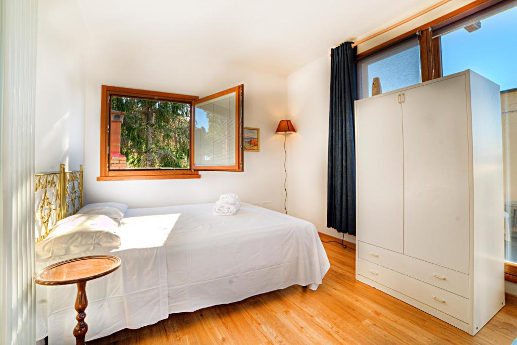 - une chambre avec un lit blanc et une fenêtre dans l'établissement Attic Luna Blu, à Sienne