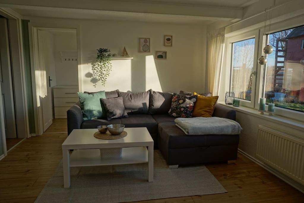 a living room with a couch and a coffee table at Abschalten in der Natur in Ahrenshöft