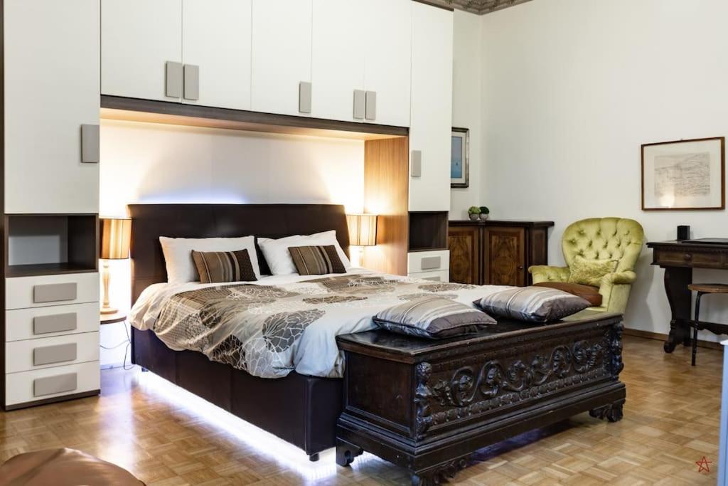 a bedroom with a large bed and a desk at Arena-Center Luxury Apartment in Verona