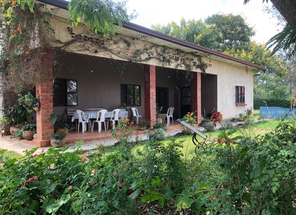 una casa con patio, tavolo e sedie di Lakeside Fish Farm a Bugesera