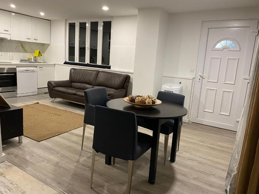 a kitchen and living room with a table and chairs at Open Home - Lisbon/Almada in Almada