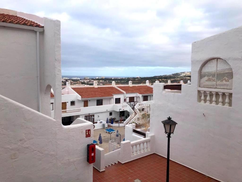 a view of a white building with a street light at 91 Port Royale Los Cristianos in Los Cristianos