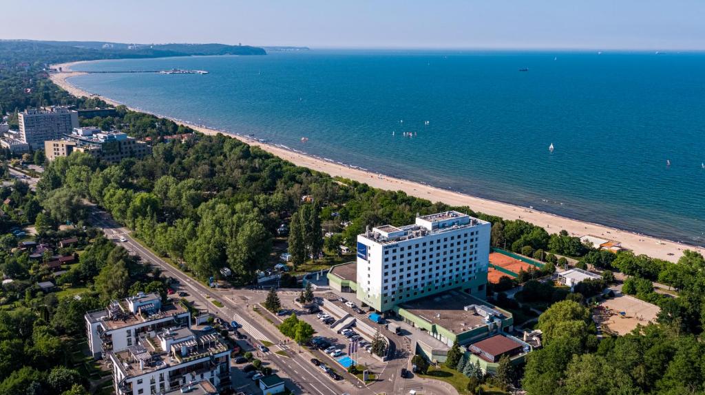 an aerial view of a beach and a building at Novotel Gdańsk Marina in Gdańsk