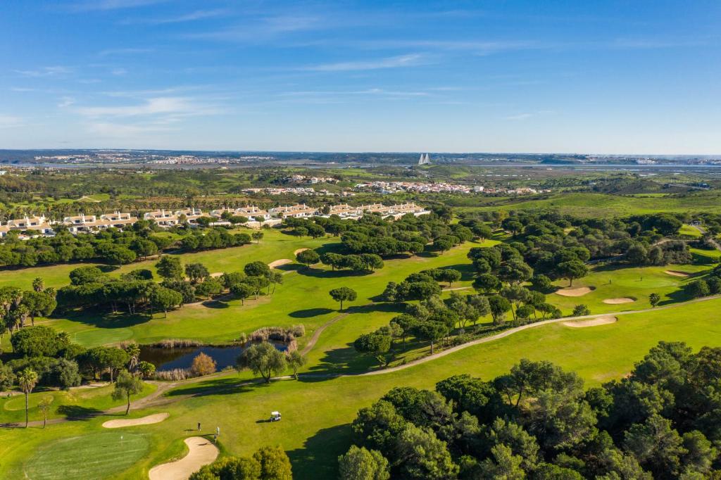 an overhead view of a golf course with trees at Castro Marim Golfe and Country Club in Castro Marim