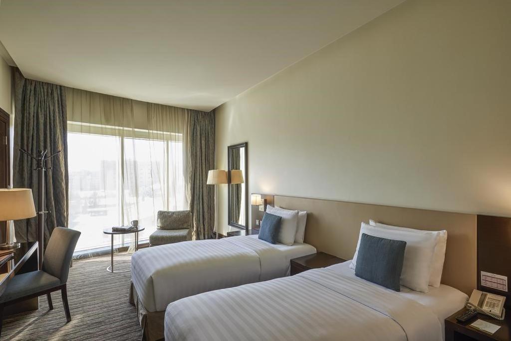 Ένα ή περισσότερα κρεβάτια σε δωμάτιο στο Safir Hotel Doha