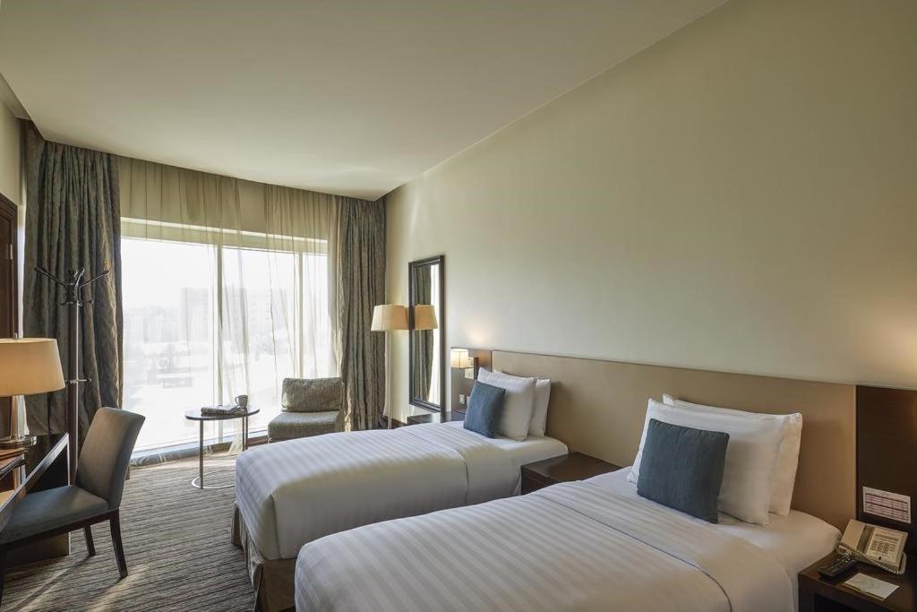 Postel nebo postele na pokoji v ubytování Safir Hotel Doha