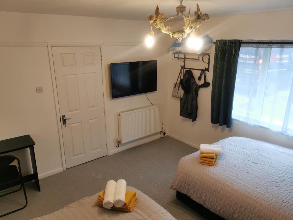a bedroom with two beds and a tv on the wall at 116 Maison Dieu Road Room A in Dover in Dover
