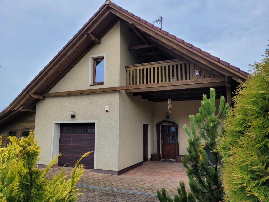 a house with a balcony on top of it at Apartmány Velké Dářko in Škrdlovice