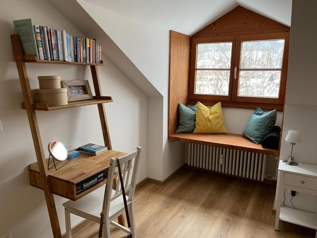 a room with a window seat with a desk and a chair at FeWo Immenstadt Apartment in Immenstadt im Allgäu