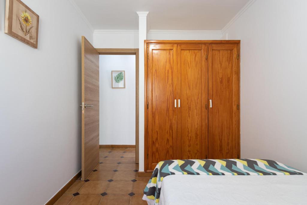 A bed or beds in a room at HomeForGuest A piece of oasis in the South of Gran Canaria
