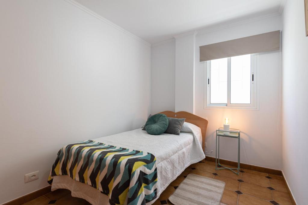 A bed or beds in a room at HomeForGuest A piece of oasis in the South of Gran Canaria