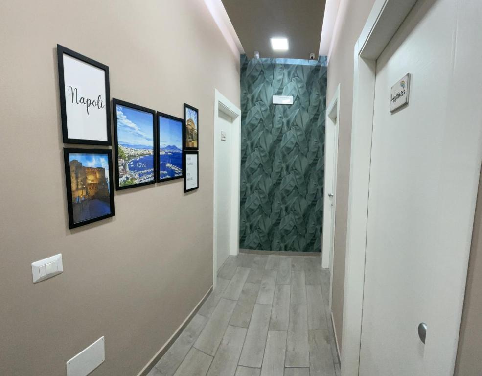 a hallway with a walk in shower and pictures on the wall at Valentine’s house in Naples