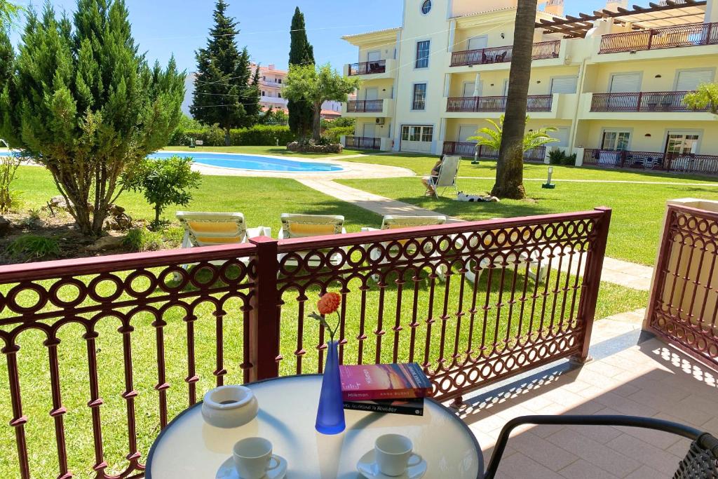 a table on a balcony with a view of a yard at Bogart at Casablanca by OCvillas in Albufeira