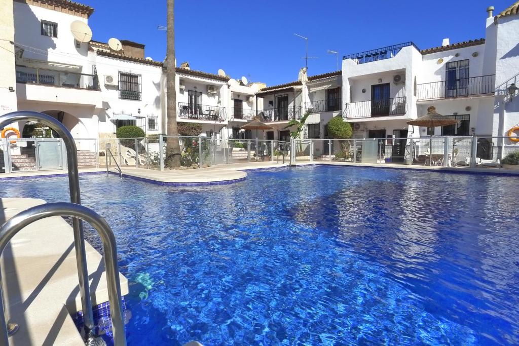 a large swimming pool in front of some buildings at Casa Andaluz in Nerja