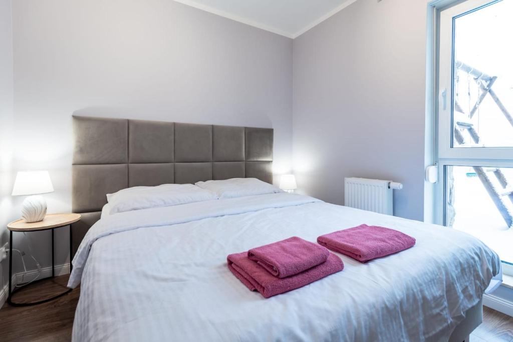Posteľ alebo postele v izbe v ubytovaní Apartament Zaciszny