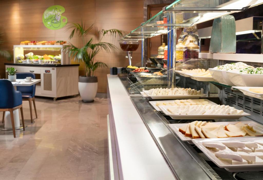 a buffet line with trays of food in a restaurant at Crowne Plaza Florya Istanbul by IHG in Istanbul