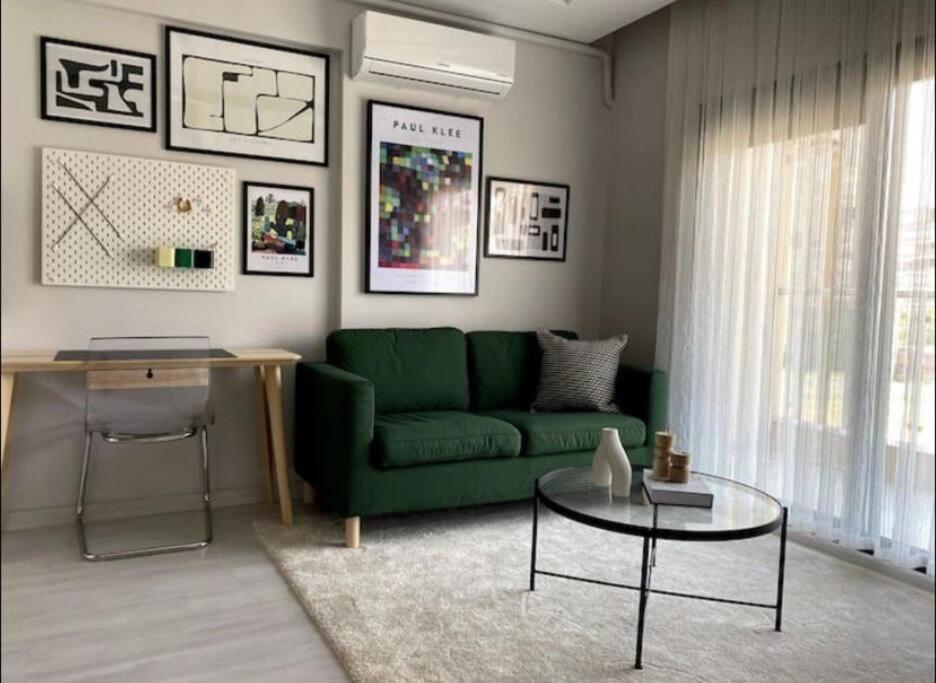 uma sala de estar com um sofá verde e uma mesa em Beşiktaşta Rahat Daire em Istambul