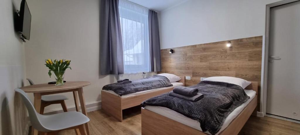 Posteľ alebo postele v izbe v ubytovaní Apartament, Pokoje Koniczynka