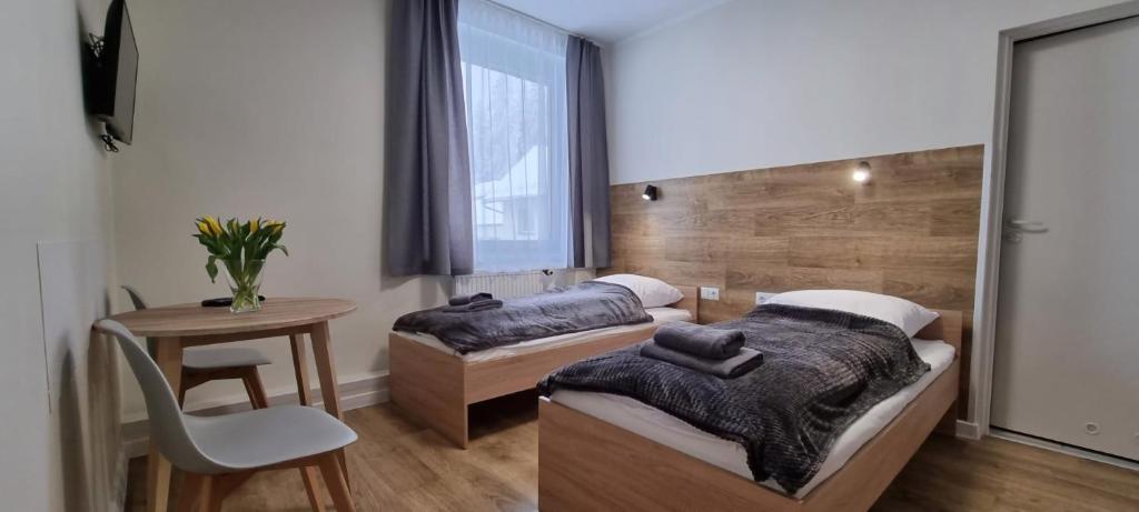 Posteľ alebo postele v izbe v ubytovaní Apartament, Pokoje Koniczynka