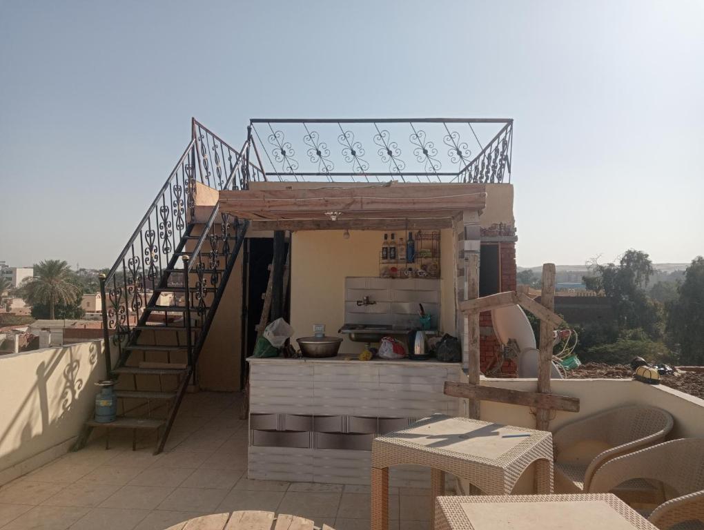 a balcony with a kitchen and stairs on a roof at Sphinx Dream Nights Cairo in Cairo