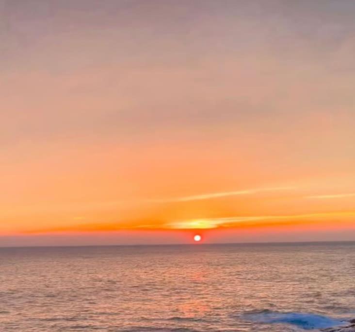 a sunset over the ocean with the sun in the sky at Appartamento Ellidor in Lido di Jesolo