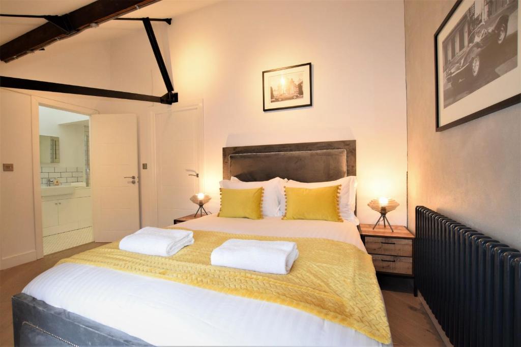 a bedroom with a large bed with yellow pillows at Nap Bristol City Centre in Bristol