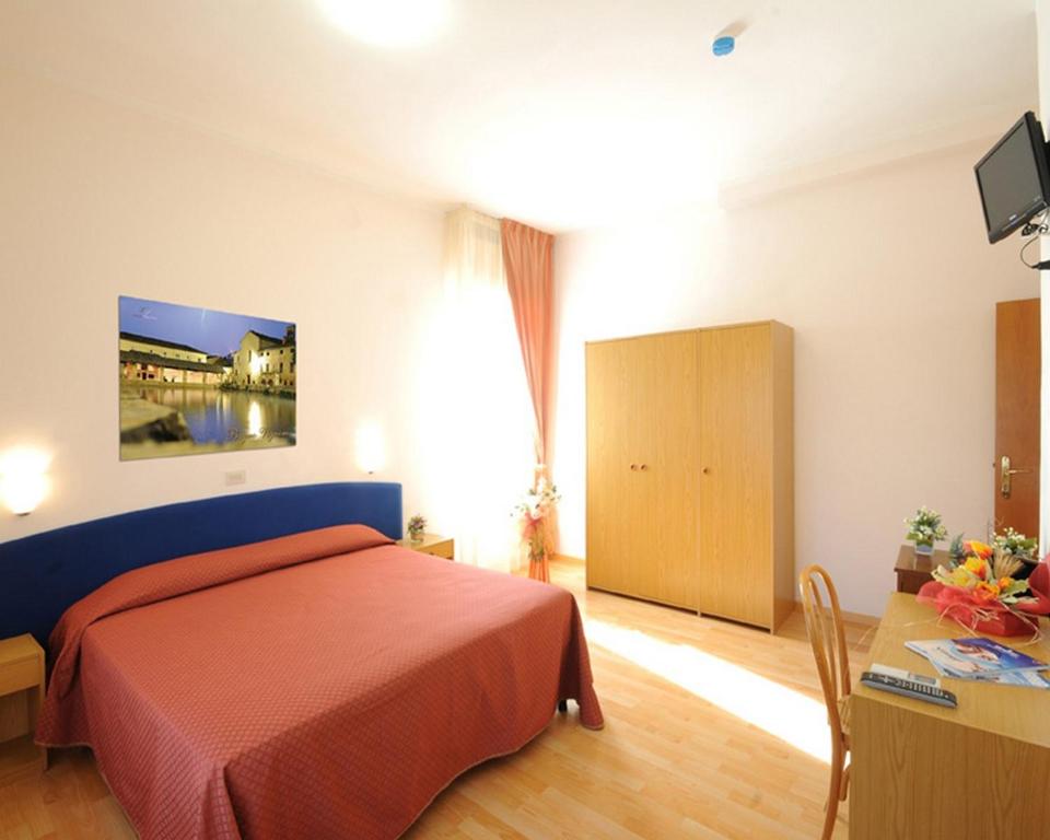 Postel nebo postele na pokoji v ubytování Hotel Perugina