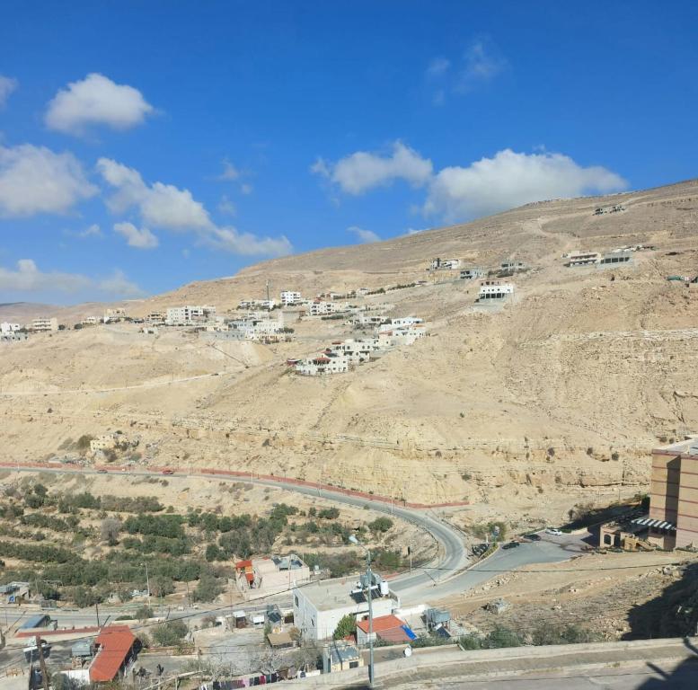 a view of a town on a hill with a road at Magic view apartment in Wadi Musa