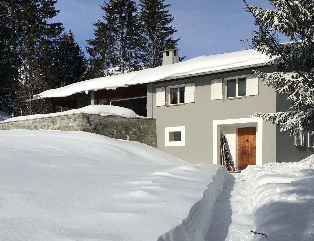 a house with a pile of snow in front of it at Adele (704 De) in Lenzerheide
