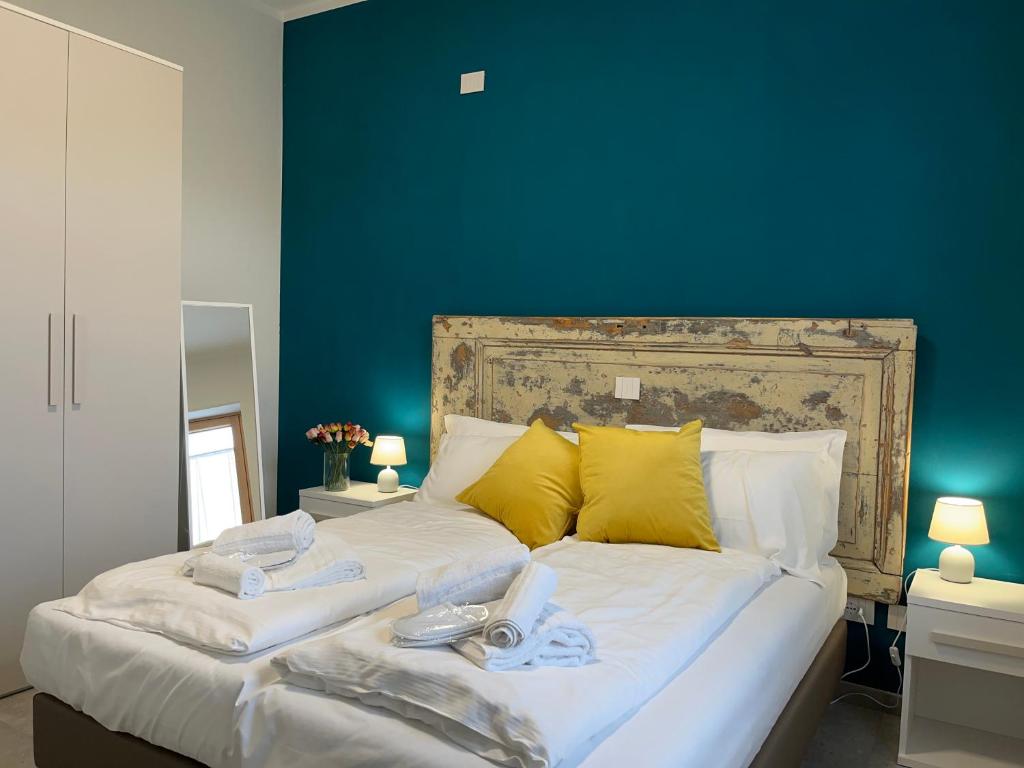 1 dormitorio con 1 cama grande y pared azul en La Corte in Fiera, en Verona