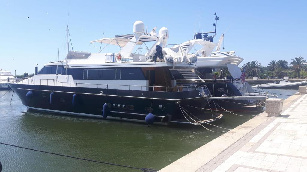 a black and white boat parked in the water at Yatch Nelly Blue Rome in Lido di Ostia