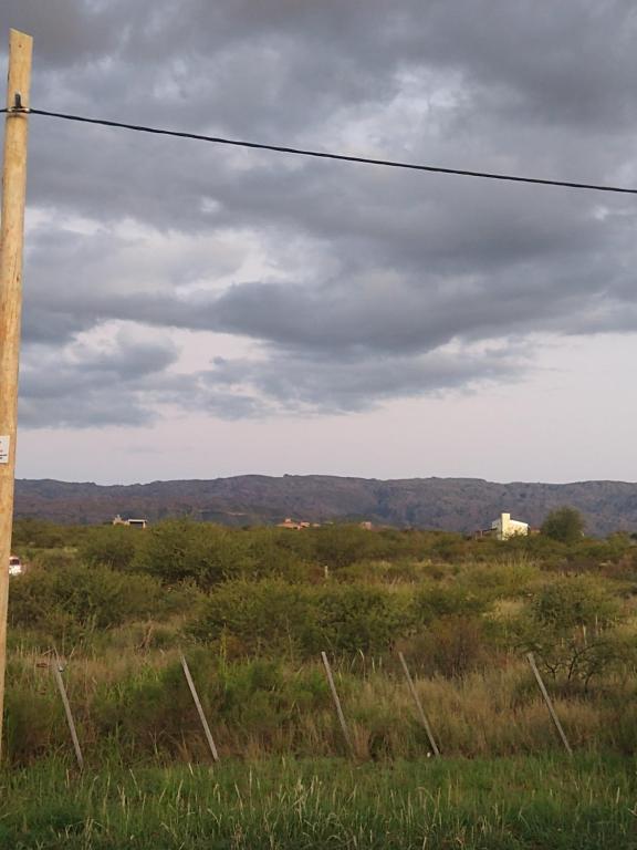 a field with a telephone pole in a field at Linda vista in Arroyo de Los Patos