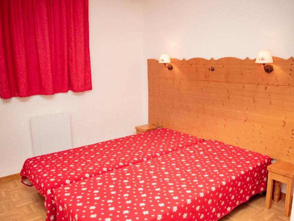 a bedroom with a bed with a red and white blanket at Appartement Puy-Saint-Vincent, 2 pièces, 4 personnes - FR-1-504-340 in Puy-Saint-Vincent