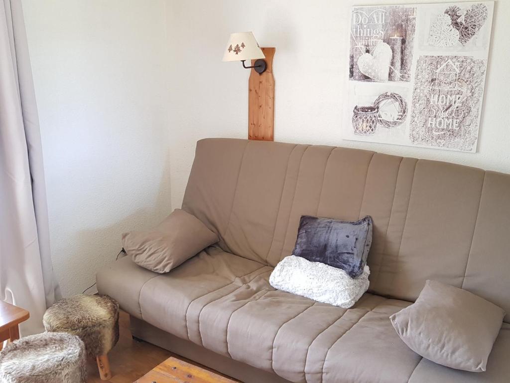 - un canapé avec un oreiller dans le salon dans l'établissement Studio La Joue du Loup, 1 pièce, 4 personnes - FR-1-504-363, à Saint-Étienne-en-Dévoluy