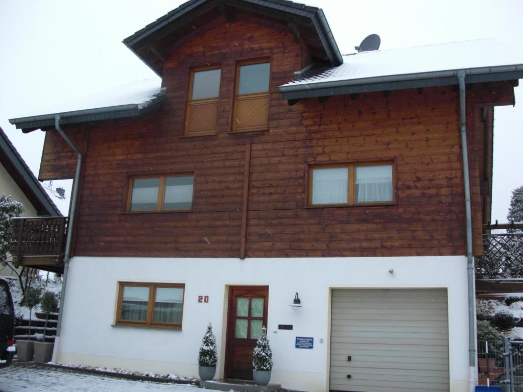 a large brick house with a garage at Ferienwohnung Bermbach in Weilburg