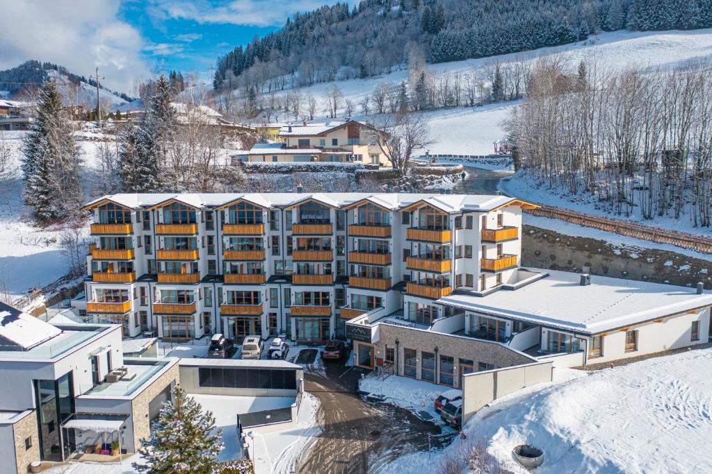 an aerial view of a hotel in the snow at Hotel Alpendorf Ski- & Sonnenresort by AlpenTravel in Sankt Johann im Pongau