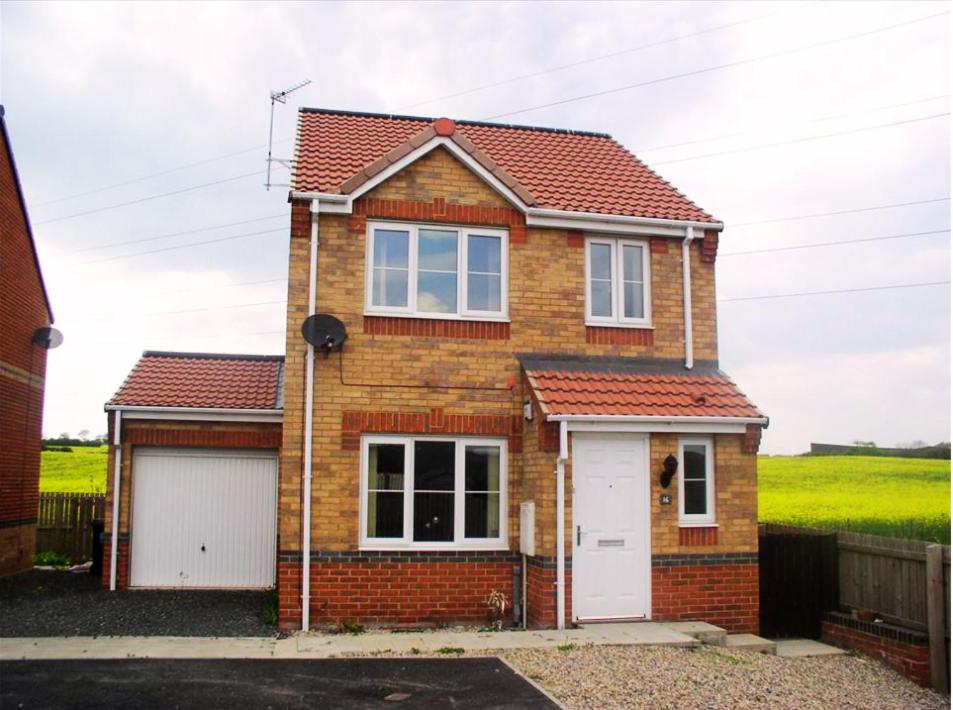 a brick house with a white garage at Comfort, peace and quiet guaranteed in this 3 bed in West Auckland